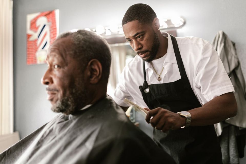 A barber focused on a client's cut